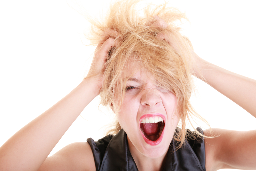 Angry furious woman screaming and pulling messy hair