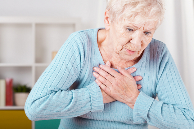 Elderly woman having heart attack